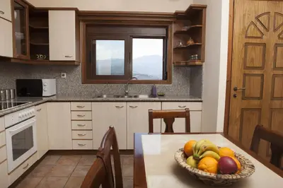 a kitchen with a bowl of fruit on a table at Aori Hillside Villa in Kántanos