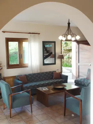 a living room with a couch and a table at Aori Hillside Villa in Kántanos
