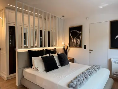 a bedroom with a large bed with black and white pillows at Ethyr Atrium in Chania Town