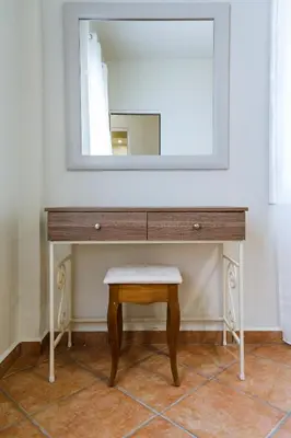 a dressing table with a stool and a mirror at Elafonisi - Cretan Serenity - Private Pool in Elafonisi