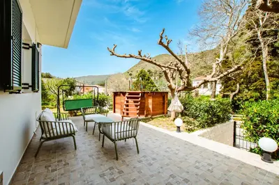 a patio with chairs and a table and a fence at Elafonisi - Cretan Serenity - Private Pool in Elafonisi