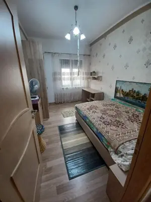 a bedroom with a bed and a table and a window at Kristy's House with garden in Chania Town
