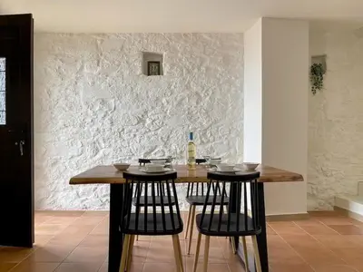 a table with two chairs and a bottle of wine at Waves - Seaside Escape in Chania Town