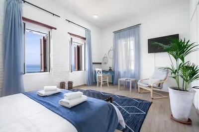 a bedroom with a bed with two towels on it at Waves - Seaside Escape in Chania Town