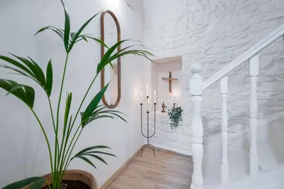 a potted plant in a hallway with a staircase at Waves - Seaside Escape in Chania Town