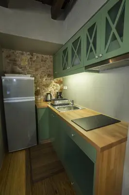 a kitchen with green cabinets and a sink at Eulogia Casa in Chania Town