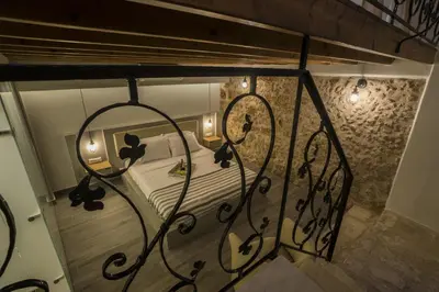 a bedroom with a bed with two lights on it at Eulogia Casa in Chania Town