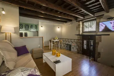 a living room with a couch and a tv at Eulogia Casa in Chania Town