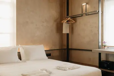 a bedroom with a bed with two towels on it at Nearchou Boutique Hotel in Chania Town