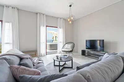 a living room with a gray couch and a tv at STR Sodi The View in Chania Town
