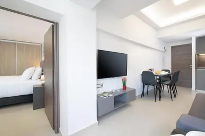 a bedroom and a living room with a bed and a table at Kappa Apartment in Chania Town