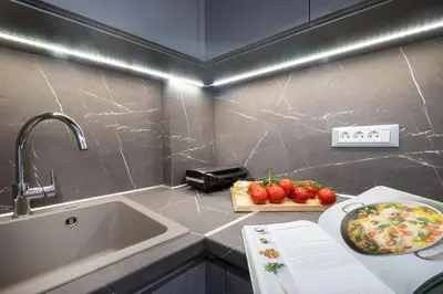a kitchen with a sink and a plate of tomatoes at Kappa Apartment in Chania Town