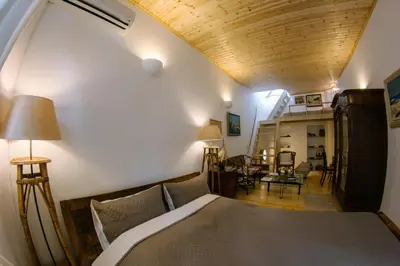 a bedroom with a bed with a wooden ceiling at La Fiora Old Town Chania in Chania Town