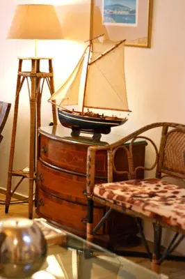 a model boat on top of a barrel with a lamp at La Fiora Old Town Chania in Chania Town