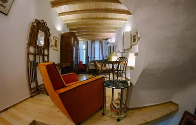a living room with a chair and a table at La Fiora Old Town Chania in Chania Town
