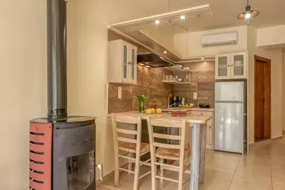 a kitchen with a table and a stove in it at Seli Chrysi - Apartment near the Sea in Kámbos