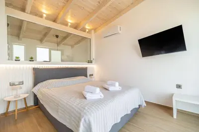 a bedroom with a bed with two towels on it at Venetian Villa by PosarelliVillas in Vamos