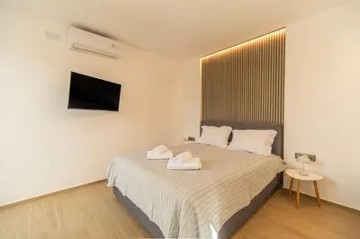 a bedroom with a bed with two towels on it at Venetian Villa by PosarelliVillas in Vamos