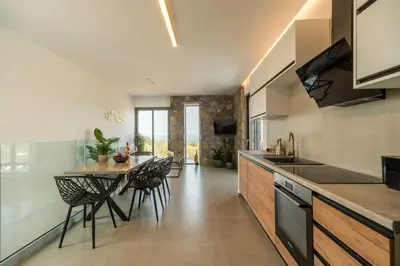 a kitchen with a table and chairs in a room at Venetian Villa by PosarelliVillas in Vamos