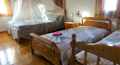 a bedroom with two beds with flowers on top of them at Villa Oneiro Tsivaras in Tsivarás