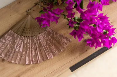 a vase of purple flowers on a wooden table at Almyrida Bay View House V BY APOKORONAS-VILLAS in Almirida