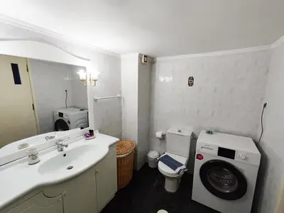 a bathroom with a sink and a washing machine at Coastal Retreat in Nea Chora in Chania Town
