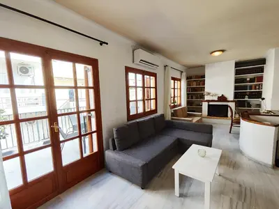 a living room with a couch and a table at Coastal Retreat in Nea Chora in Chania Town