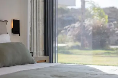 a bedroom with a bed and a large window at Blue Olive Luxury Villa in Kounoupidhianá