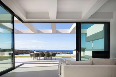 a living room with a view of the ocean at Blue Olive Luxury Villa in Kounoupidhianá