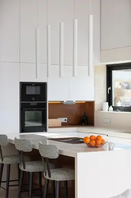 a kitchen with white cabinets and a counter with oranges on it at Blue Olive Luxury Villa in Kounoupidhianá