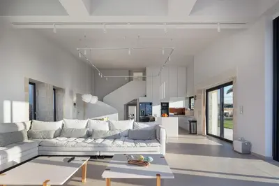 a living room with a white couch and a table at Blue Olive Luxury Villa in Kounoupidhianá