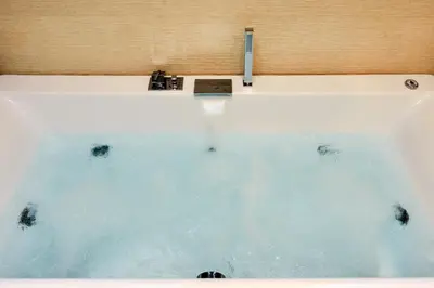 a bath tub with water coming out of it at Villa Melitini in Souda