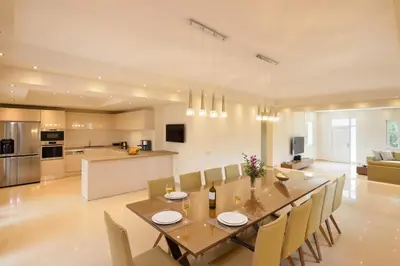 a dining room and kitchen with a table and chairs at Villa Melitini in Souda