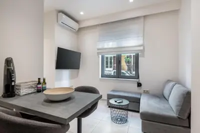 a living room with a table and a couch at Harma City Living in Chania Town