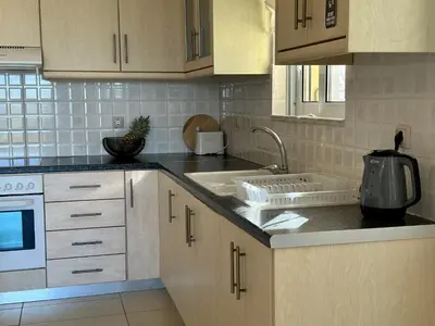 a kitchen with a sink and a counter top at Aegean View Villa, 2-min Drive to Almyrida Beach in Almirida