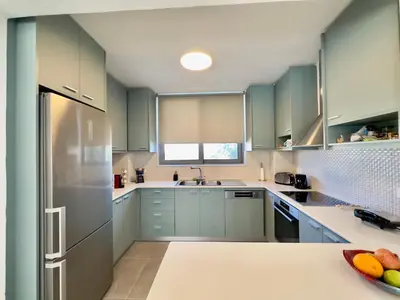 a kitchen with mint green cabinets and a refrigerator at Villa Eleni, Vamos Sea & Mountain View with Pool in Chania