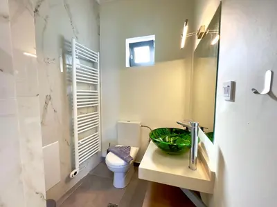 a bathroom with a sink and a toilet and a mirror at Villa Eleni, Vamos Sea & Mountain View with Pool in Chania