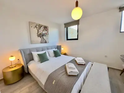 a bedroom with a large bed with green pillows at Villa Eleni, Vamos Sea & Mountain View with Pool in Chania