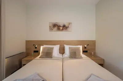 a bedroom with a large bed with white sheets at Villa JOY in Módhion