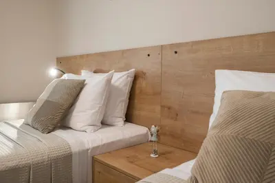 a bedroom with two beds with white pillows at Villa JOY in Módhion