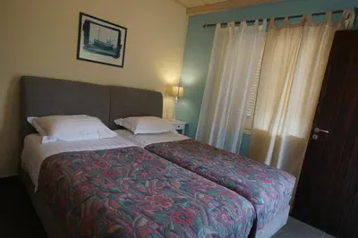 a bedroom with a bed with a colorful blanket at Seaside Cottage in Kato Daratso