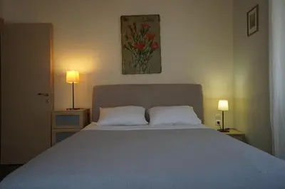 a bedroom with a large bed with two pillows at Seaside Cottage in Kato Daratso