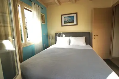 a bed in a room with a window and a bed sidx sidx sidx at Seaside Cottage in Kato Daratso