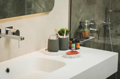 a bathroom counter with a sink and a mirror at Lovelia Luxury Apartment Chania EV Car Wallbox in Chania Town
