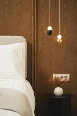 a bedroom with a bed and a table with a vase at Lovelia Luxury Apartment Chania EV Car Wallbox in Chania Town