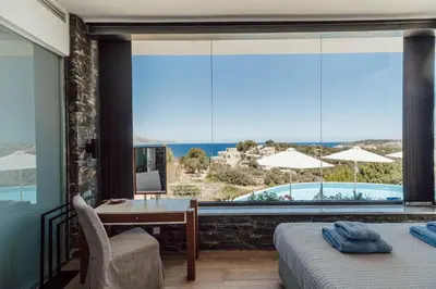 a bedroom with a desk and a view of a pool at Villa Kera Panorama by PosarelliVillas in Vamos