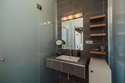 a bathroom with a sink and a mirror at Villa Kera Panorama by PosarelliVillas in Vamos