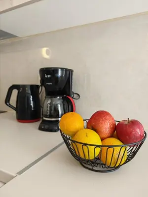 a bowl of fruit on a counter with apples and oranges at Casa di Rosa in Chania Town