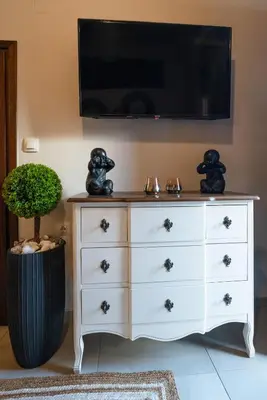 a dresser with a flat screen tv above it at Dreamscape Residences - Zephi Suite in Chania Town