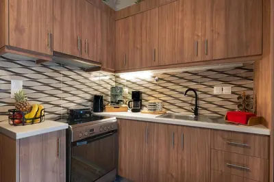 a kitchen with wooden cabinets and a stove top oven at Dreamscape Residences - Zephi Suite in Chania Town